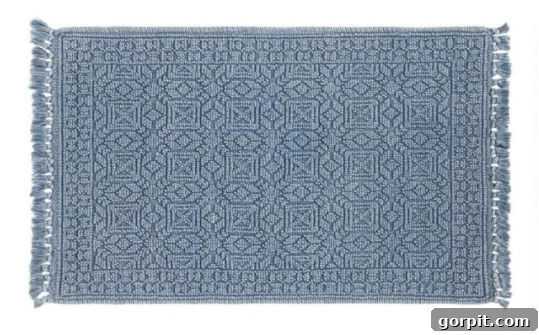 Stylish Bath Mats for Vibrant Bathrooms 5 One of the best bath mats for color lovers include this blue textured geometric bath mat.