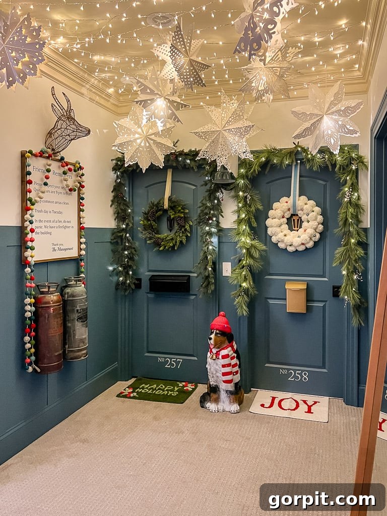 Girls' bedroom doors decorated with festive Christmas garlands, wreaths, and lights, resembling apartment entrances