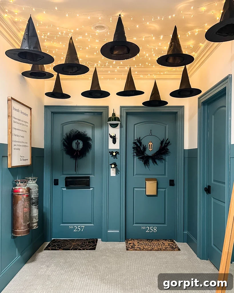 Kids' bedroom doors decorated to look like apartment doors with fun and spooky Halloween decor, including spiderweb and Ouija board doormats