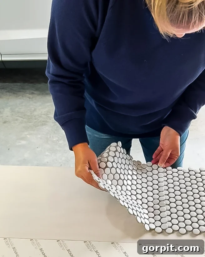 Personalized Message Headboard: Build Your Own 7 Laying penny tiles on the adhesive mat for the DIY headboard