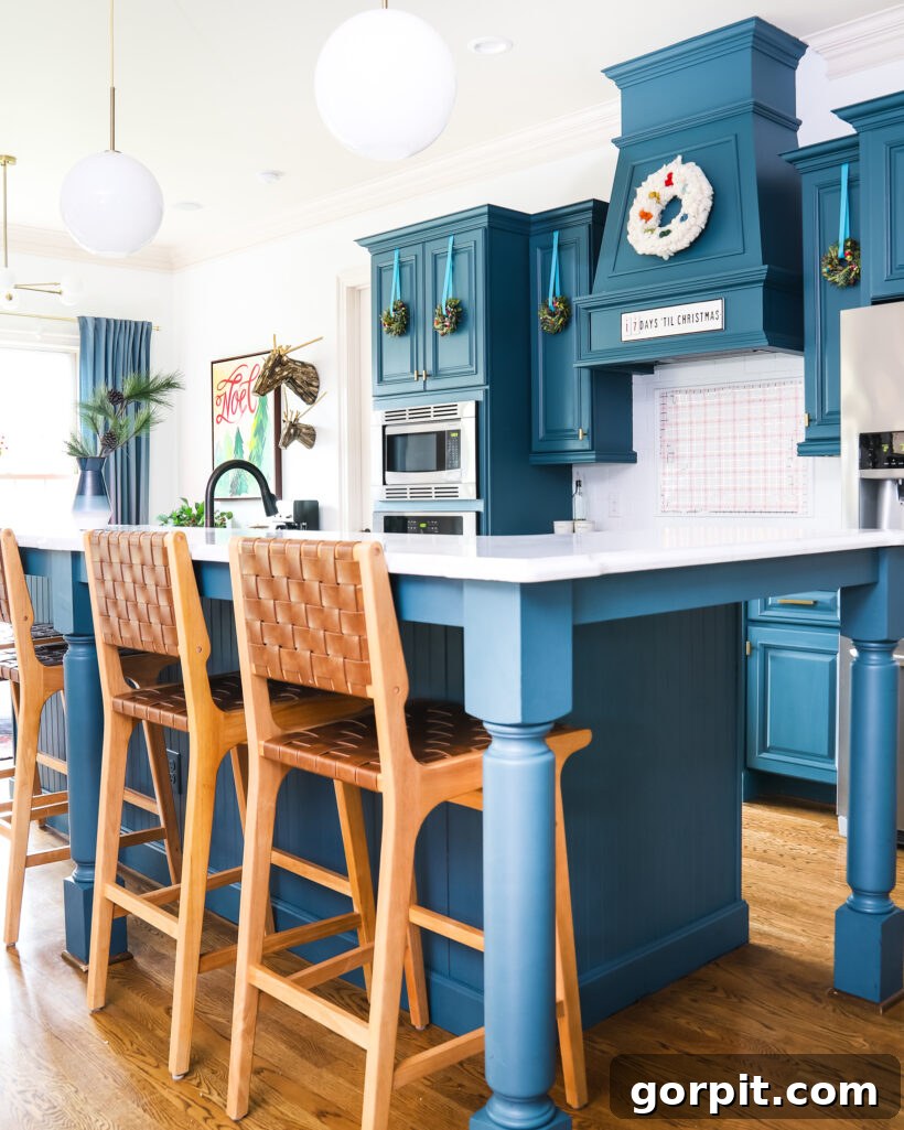 Our 2021 Christmas Home A Kaleidoscope of Color 5 A beautifully decorated blue kitchen for Christmas, showcasing festive accents and thoughtful design.