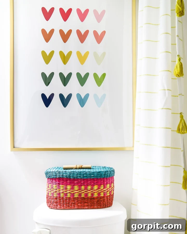No bathroom makeover on a budget is complete without colorful artwork like rainbow heart artwork and a rainbow toilet paper basket. 