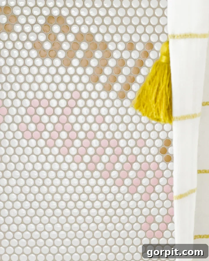 White penny tile in shower has been customized to add the word "smiling" in two different colors.