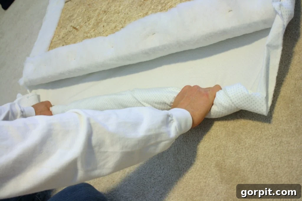 DIY Upholstered Headboard You Can Make This Afternoon 10 Upholstering the DIY headboard with chosen fabric