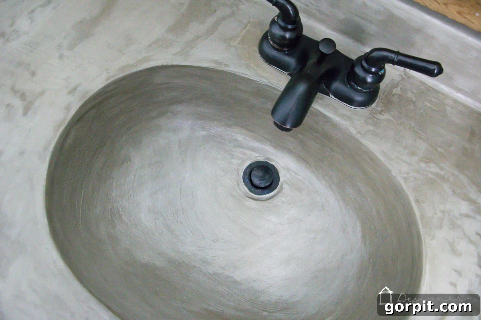 Close-up of DIY concrete sink in a redesigned bathroom