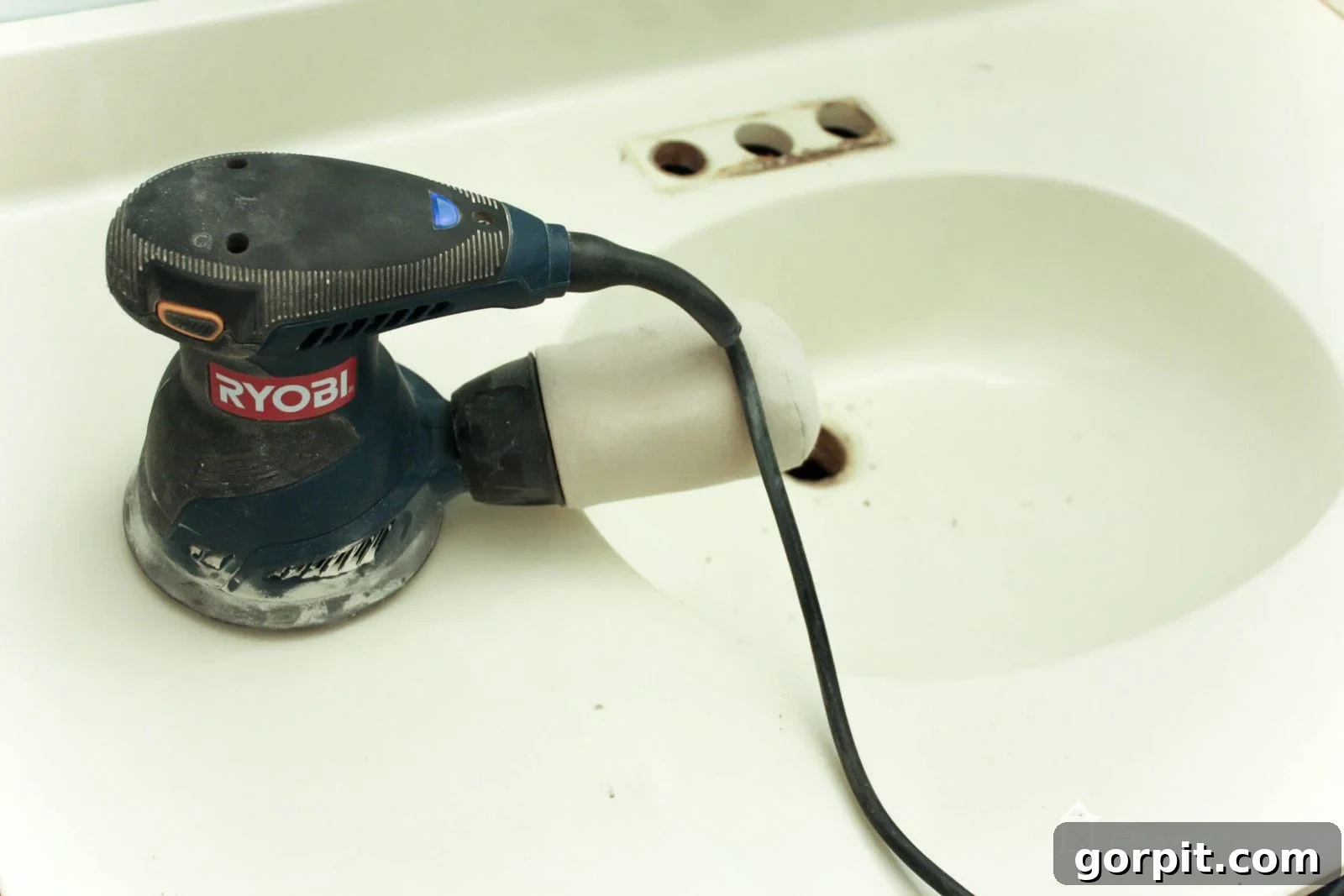 Sanding a cultured marble vanity top before applying concrete overlay