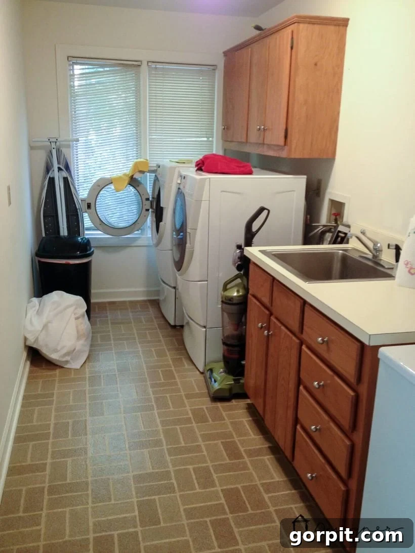 Before photo of an outdated brick pattern vinyl floor in a laundry room