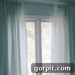 GENIUS! Learn how to make curtains out of sheets! Full tutorial by Designer Trapped in a Lawyer's Body. Showcase of finished back-tab curtains.