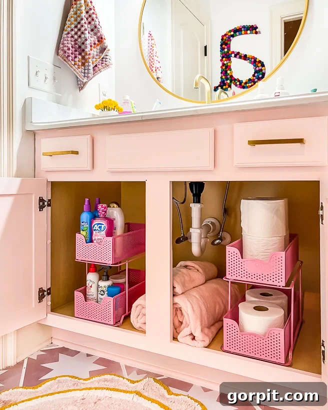 An organized and decluttered bathroom cabinet in a girl's bathroom, showing neatly arranged toiletries.