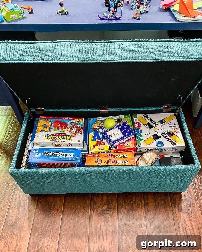 Kids' board games and toys neatly hidden within a stylish storage bench in a living room.