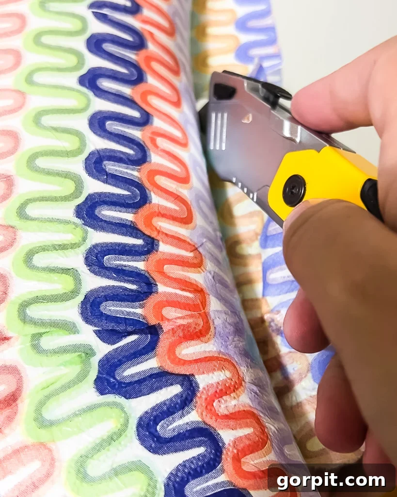 Trimming excess napkin material from the inner edge of the mirror frame