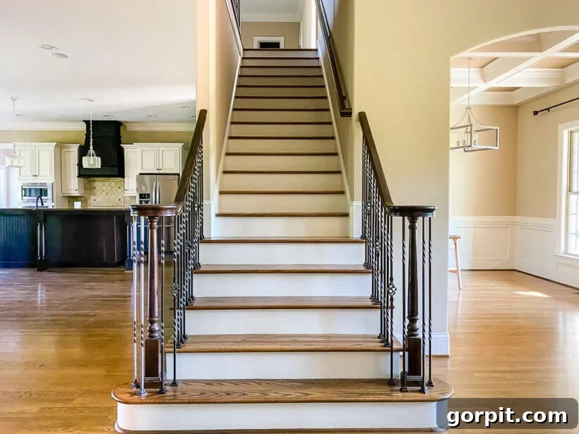Before photo of an outdated stair railing with iron balusters
