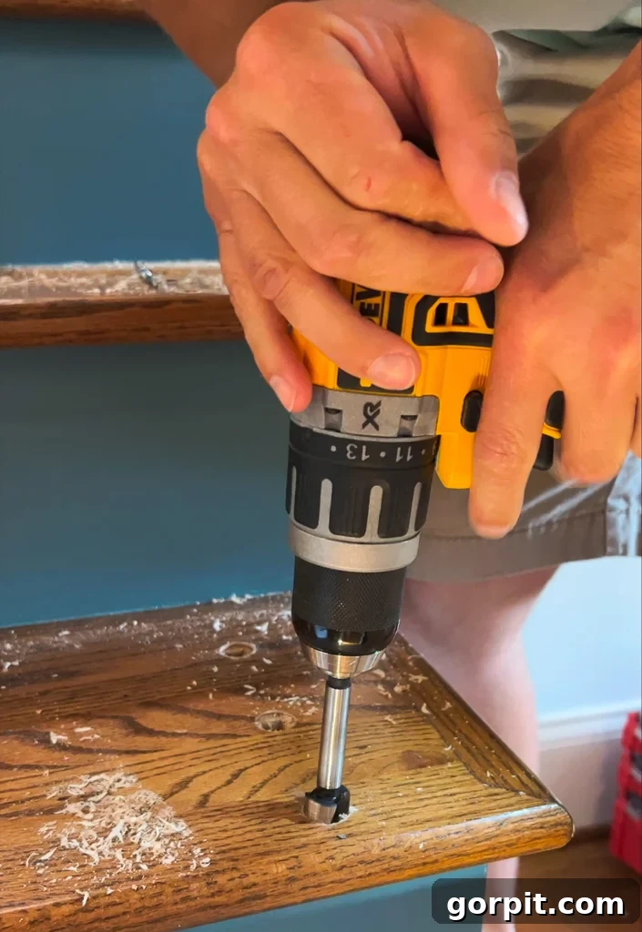 Cleaning and resizing baluster holes in stair treads with a drill and Forstner bit