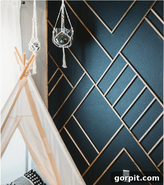 Transform Your Walls with DIY Board and Batten 15 Warm wood-toned batten pieces are artfully arranged in distinctive geometric shapes against a vibrant deep turquoise wall, creating a captivating and unique boho-inspired design.