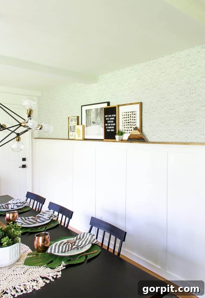 Transform Your Walls with DIY Board and Batten 17 A pristine white board and batten wall is enhanced by a beautifully stained wood photo ledge, creating a unique and elegant dining room gallery display that combines classic and modern elements.