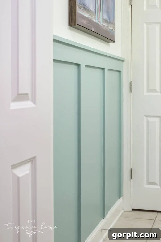 Transform Your Walls with DIY Board and Batten 24 A refreshing light blue bathroom is given a crisp, new look with halfway board and batten walls, elegantly finished with white trim, creating a bright and inviting atmosphere.