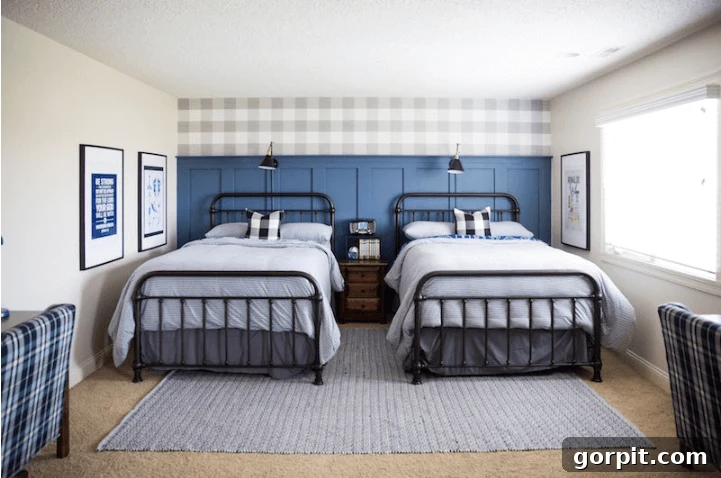 Transform Your Walls with DIY Board and Batten 7 Two twin beds, neatly decorated in soothing blue tones, are set against a dramatic dark blue board and batten accent wall, topped with a classic buffalo plaid wallpaper for a cozy, sophisticated look.
