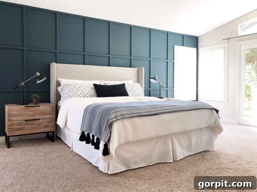 Transform Your Walls with DIY Board and Batten 8 A beautifully appointed double bed with crisp white linens and a deep blue accent pillow is positioned against a rich turquoise accent wall, featuring an elegant board and batten grid design that adds depth and sophistication.