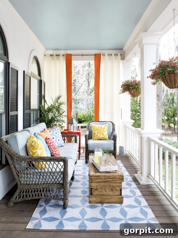 Porch Perfection: Designer Decor and Styling Tips 14 porch with blue and orange accents and pattered pillows