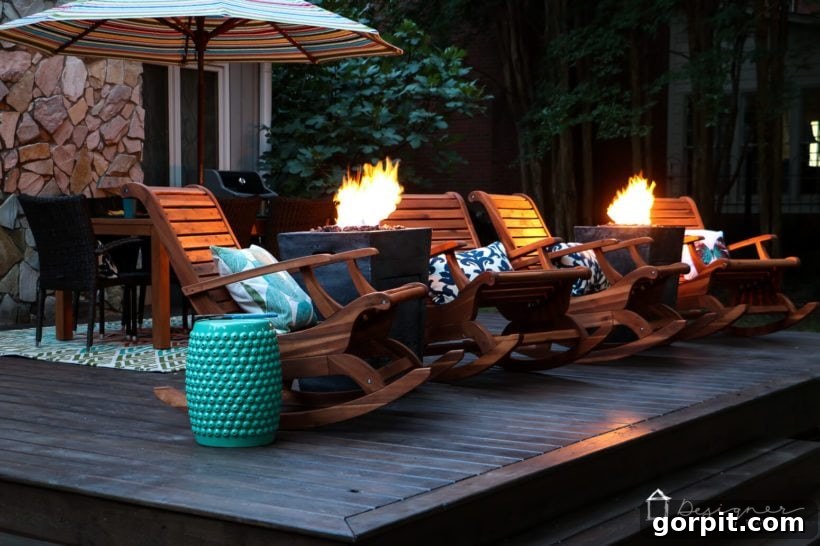 Porch Perfection: Designer Decor and Styling Tips 3 teak chairs and fire columns on back porch at dusk