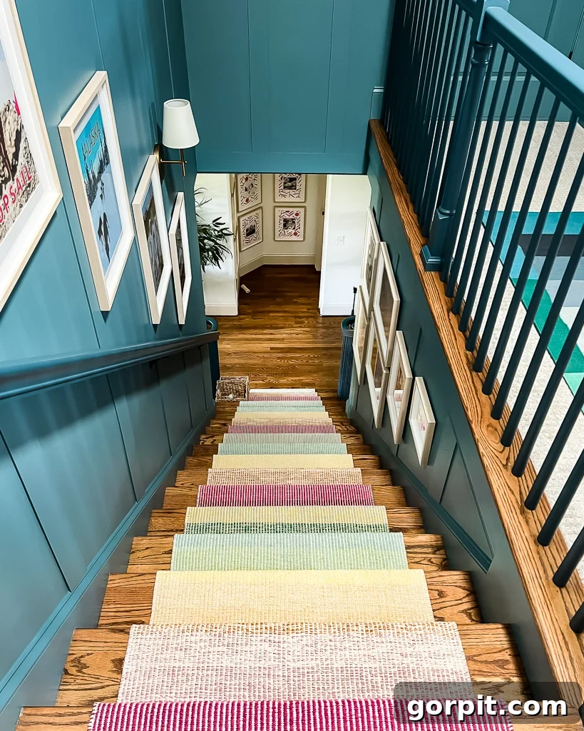 Vibrant blue staircase adorned with colorful artwork and a newly installed stair runner, showcasing the 'after' effect