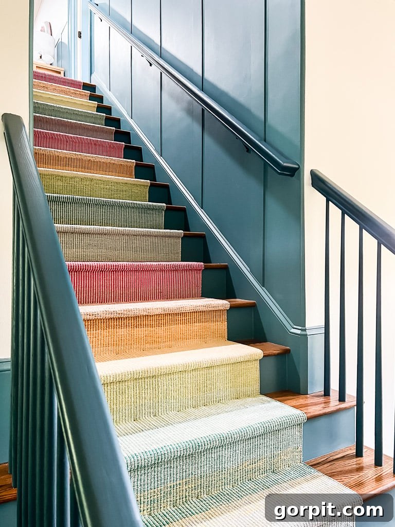 Close-up photo of a DIY stair runner installation showing visible staples