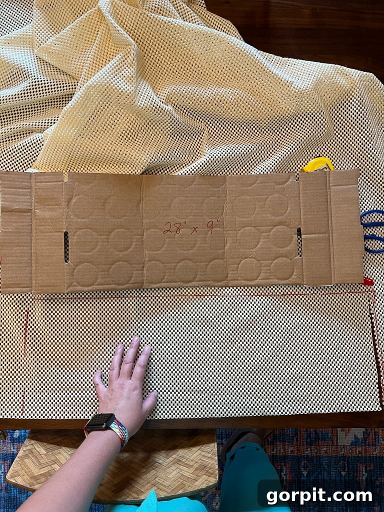 Cutting out non-slip rug pads using a cardboard template for consistency and speed