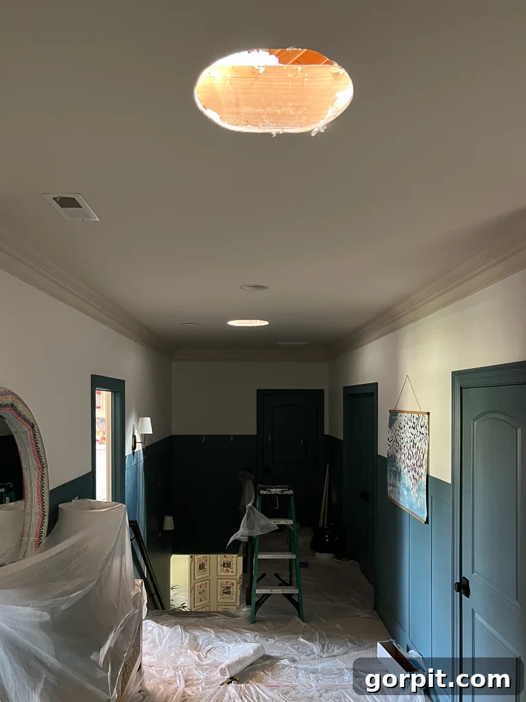 Velux sun tunnels being installed, light pouring through roof and ceiling cuts