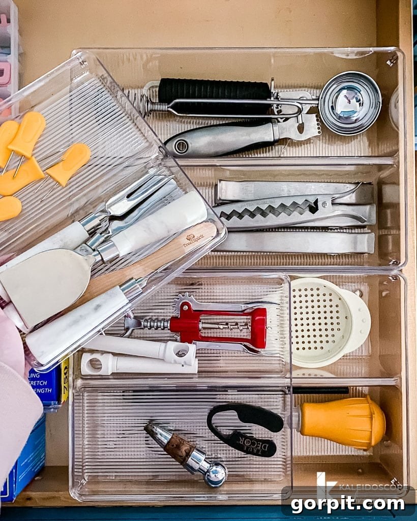 The longer kitchen drawer organizer sits below the shorter top organizer which allows for easy access to random kitchen utensils and saves a lot of space.