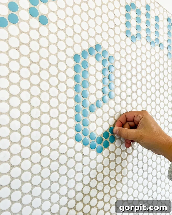 Close-up of penny tile shower with a personalized vinyl message, cut by Cricut Explore Air 2.
