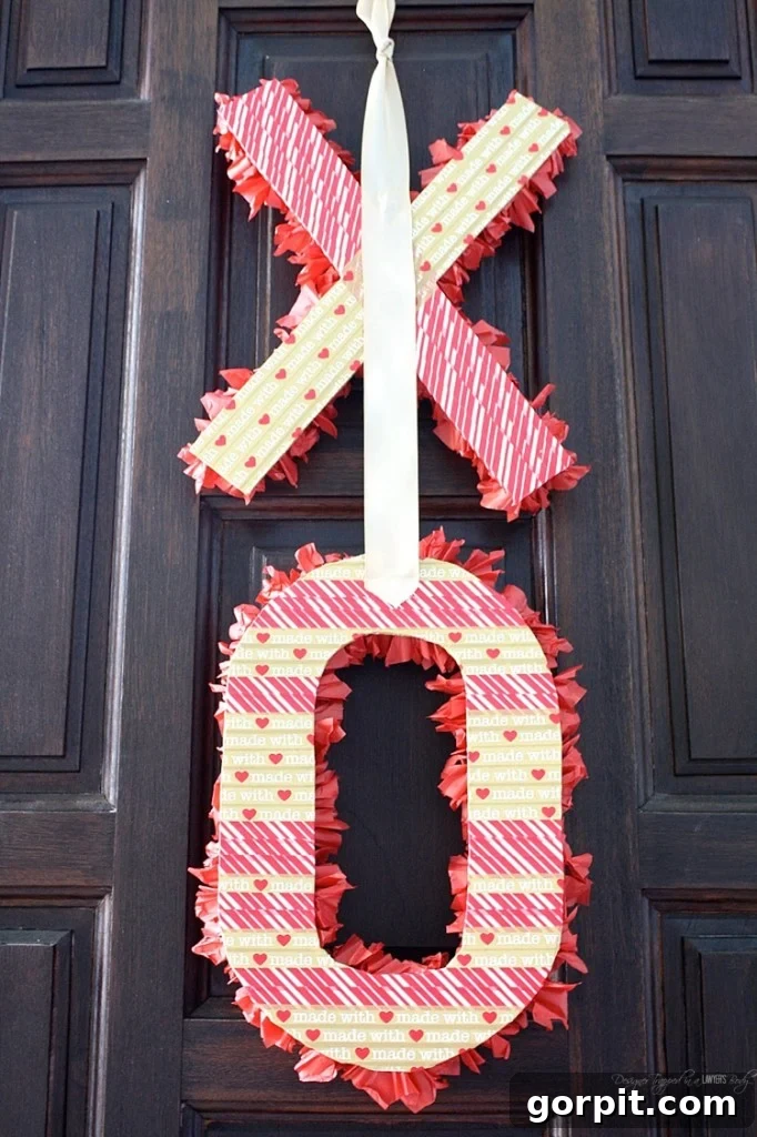 The final step: attach a beautiful gold satin ribbon with hot glue to the back of your tissue paper covered 'O' for easy hanging. Create a loop or a bow.