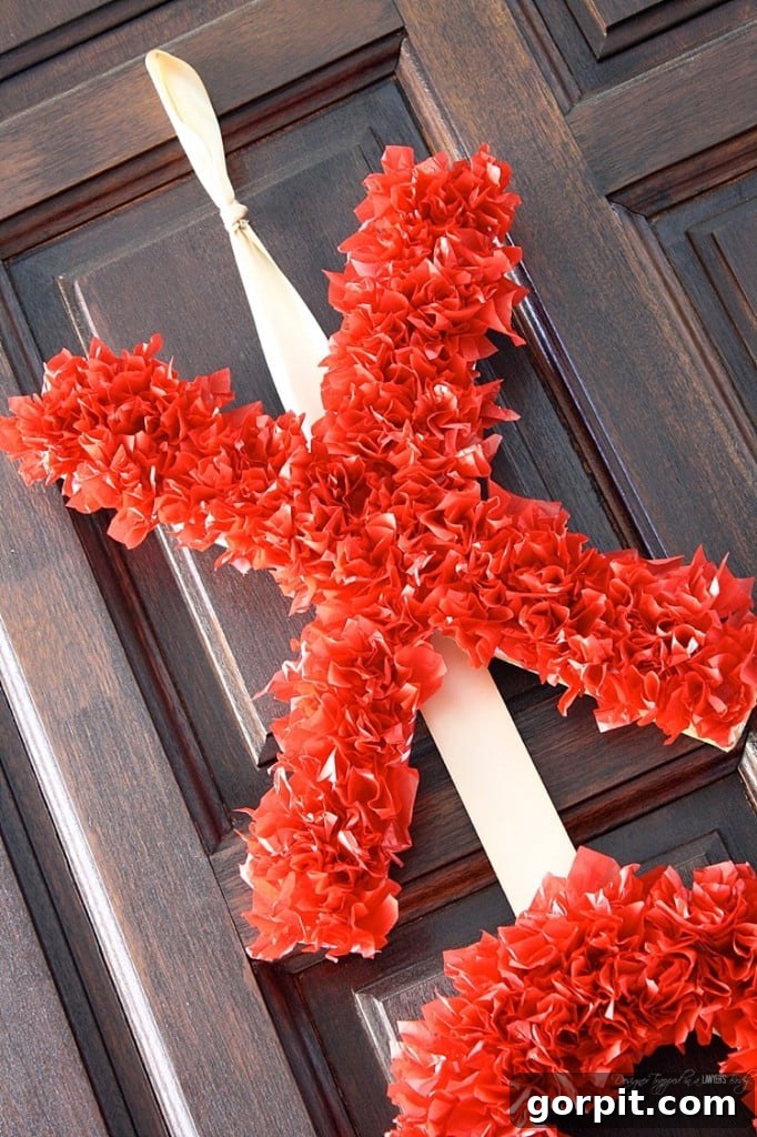 A close-up of the beautiful, textured surface of the tissue paper Valentine's wreath, showcasing its intricate and inviting fluffiness.