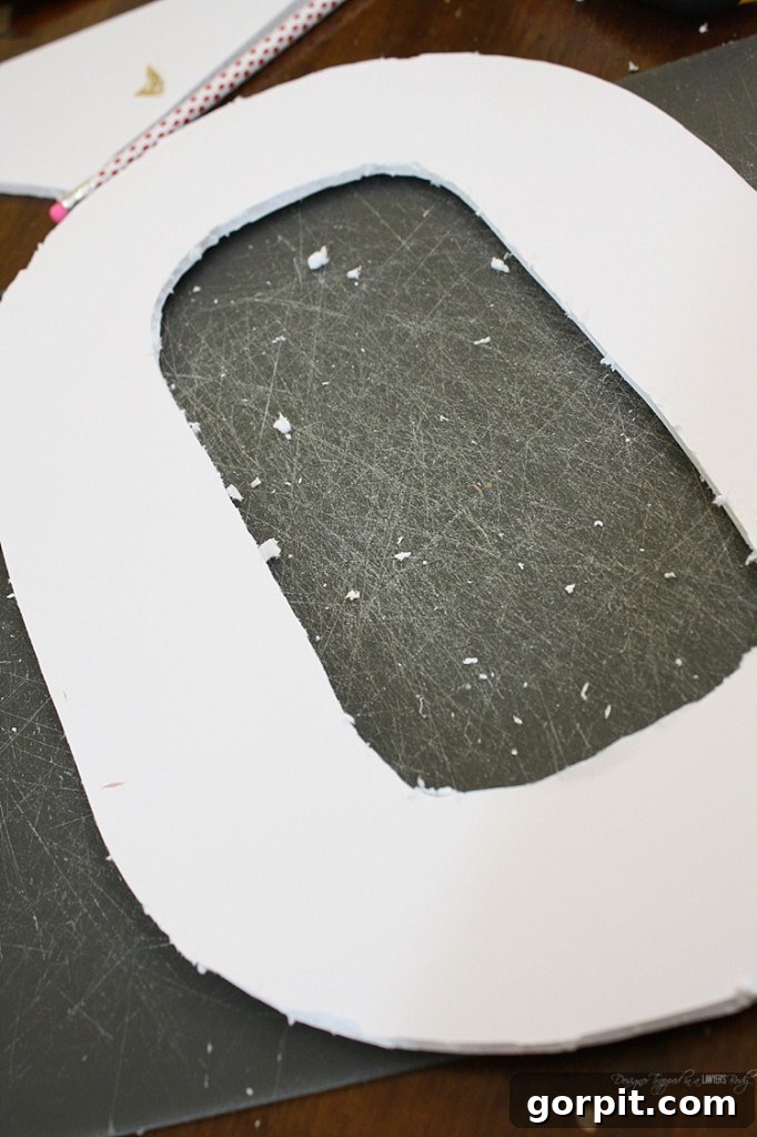 The cut foam core 'X' and 'O' shapes ready for the next step of your DIY tissue paper Valentine's wreath. These form the sturdy foundation.