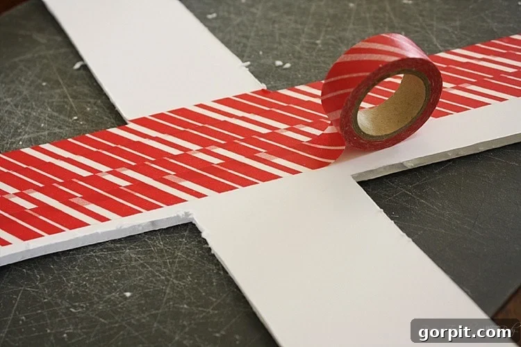 Cover the back side of your foam core letters with washi tape to hide rough edges and give your DIY Valentine's wreath a polished finish. Wrap it over the front slightly.