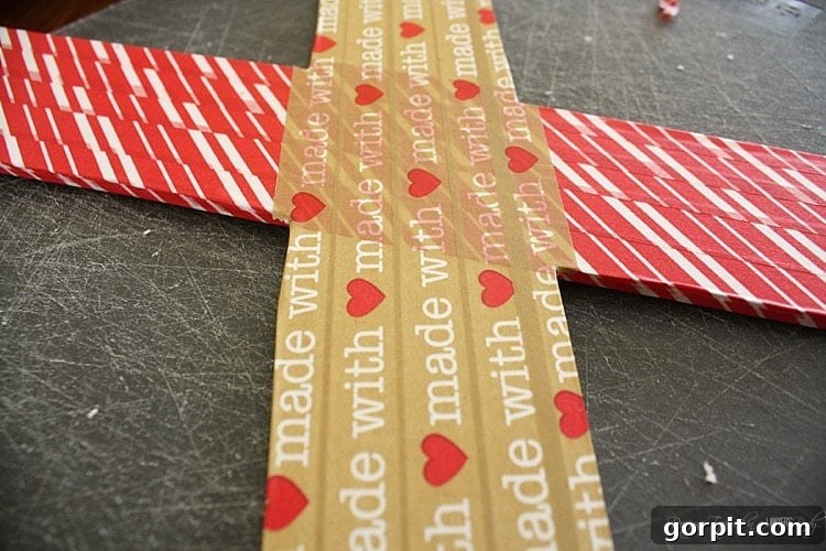 Applying washi tape along the edges of the 'O' shape, meticulously covering any imperfections for a clean and professional Valentine's Day craft.
