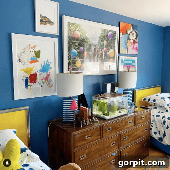 blue walls with bright colored art in shared boys' bedroom