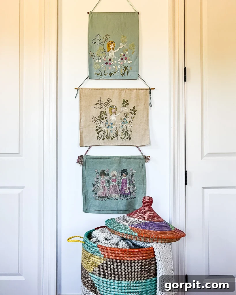 Detailed shot of the guest room decor, featuring vintage embroidered art pieces and an African-style woven basket, emphasizing textural contrast and global influences.