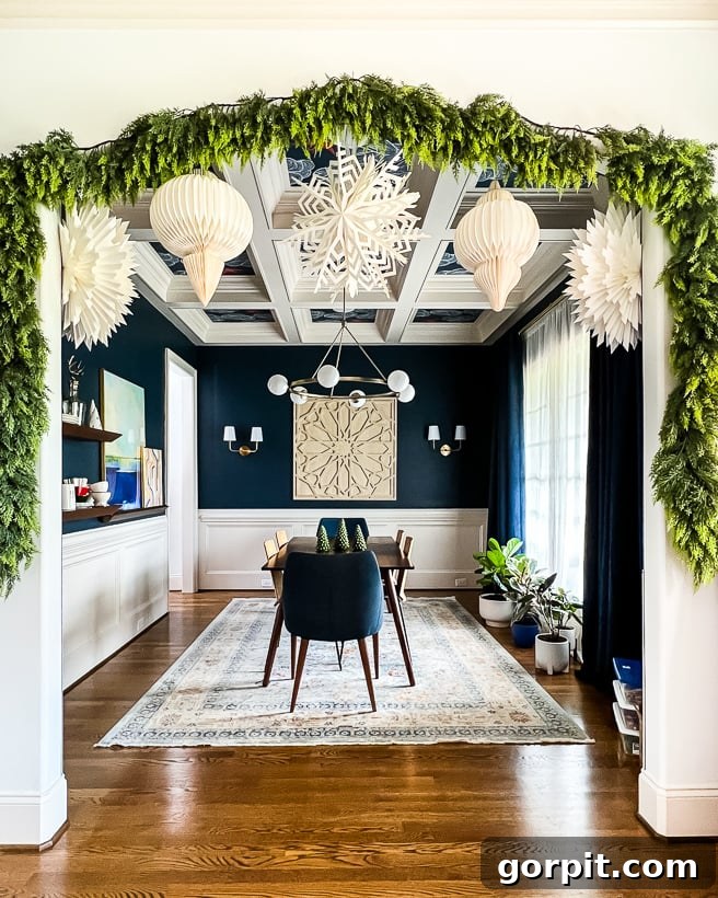 the most realistic faux cedar garland hanging in doorway to dining room