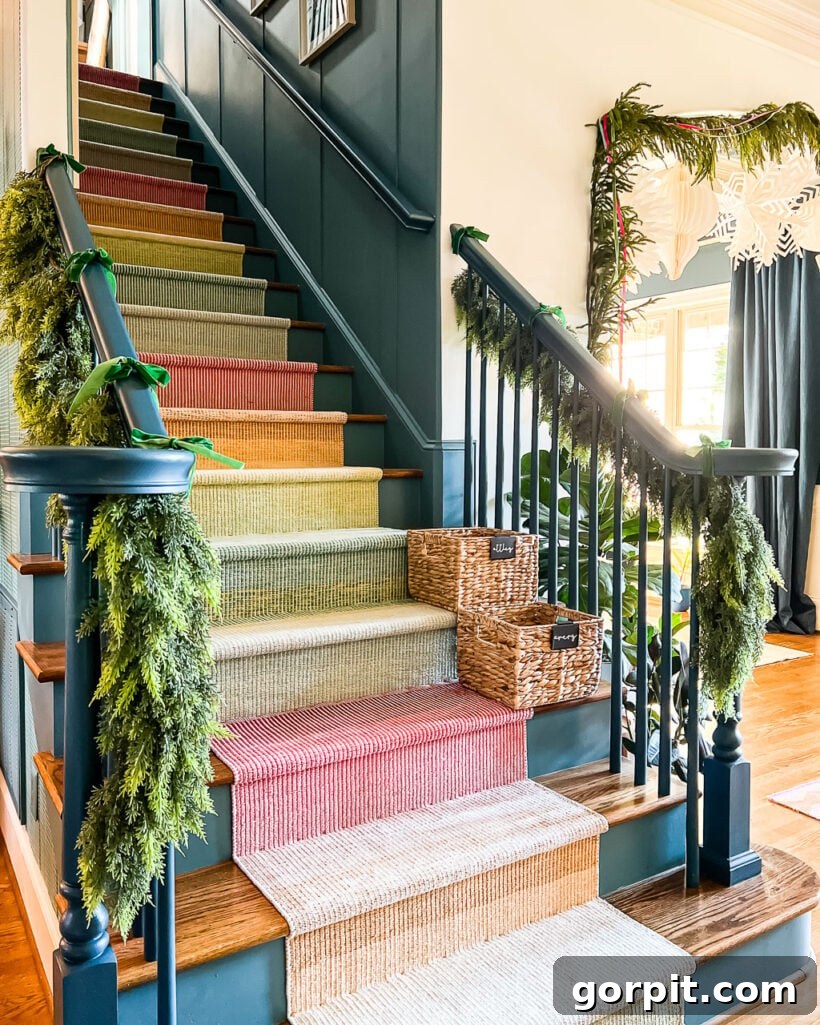 realistic faux garlands hanging on colorful staircase decorated for Christmas