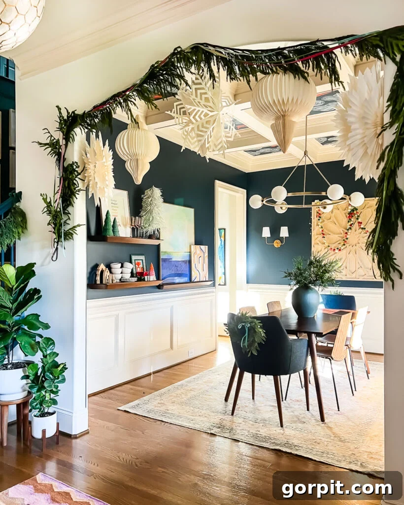 realistic norfolk pine artificial garland framing cased-opening of dining room decorated for Christmas