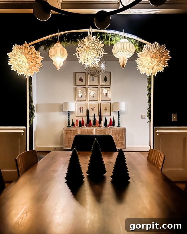 Twinkling Paper Christmas Lanterns 4 Light-up paper Christmas lanterns hanging gracefully in a dining room