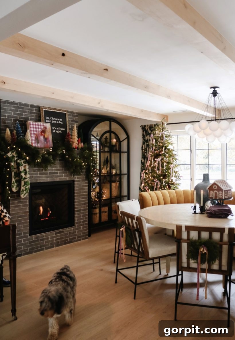 Christmas decorations in a dining room, showcasing a tree and a festively adorned fireplace, exuding warmth and coziness.