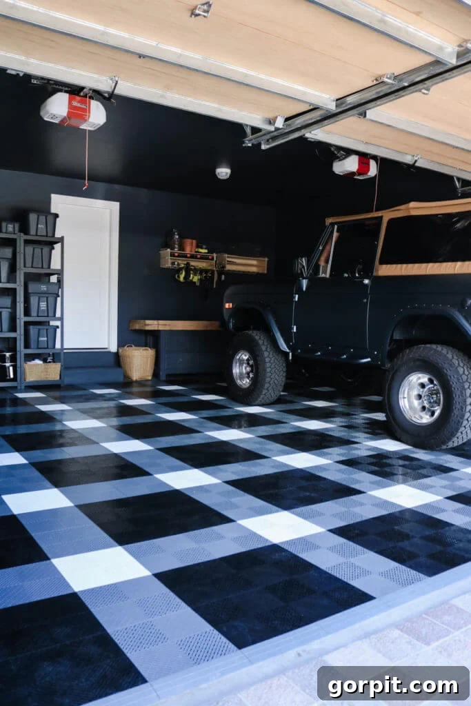 Elevate Your Garage: Smart Flooring Choices 3 A vibrant example of interlocking garage floor tiles installed in a modern garage, featuring a striking black and white checkerboard pattern that adds both style and functionality.