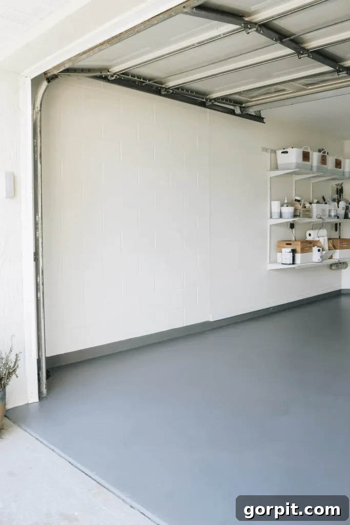 Elevate Your Garage: Smart Flooring Choices 10 A beautifully painted garage floor, demonstrating how paint can drastically improve the aesthetic and cleanliness of a garage space, creating a brighter and more inviting environment.