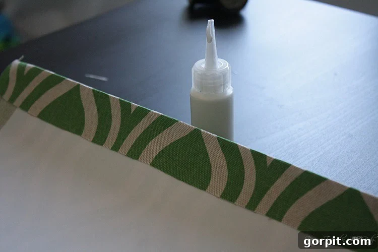 Craft Your Own Pendant Light 9 Gluing the fabric overhang on one short end of the styrene, creating a neat seam for the lampshade.