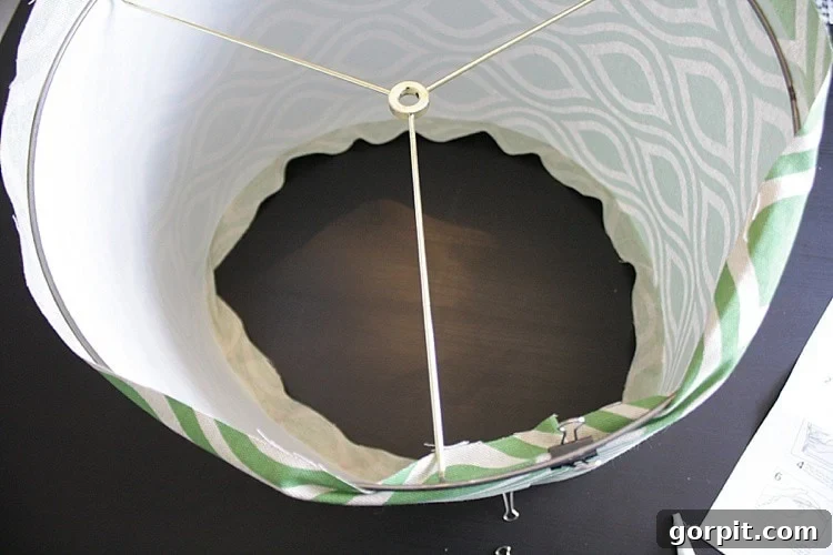 Craft Your Own Pendant Light 10 Shaping the styrene into a drum lampshade and inserting the top ring with binder clips.