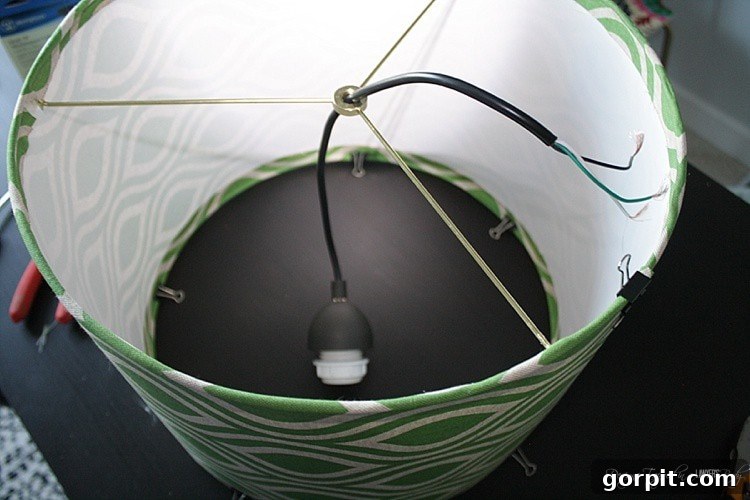 Craft Your Own Pendant Light 11 Threading the pendant light kit wire through the finial ring of the newly assembled lampshade.