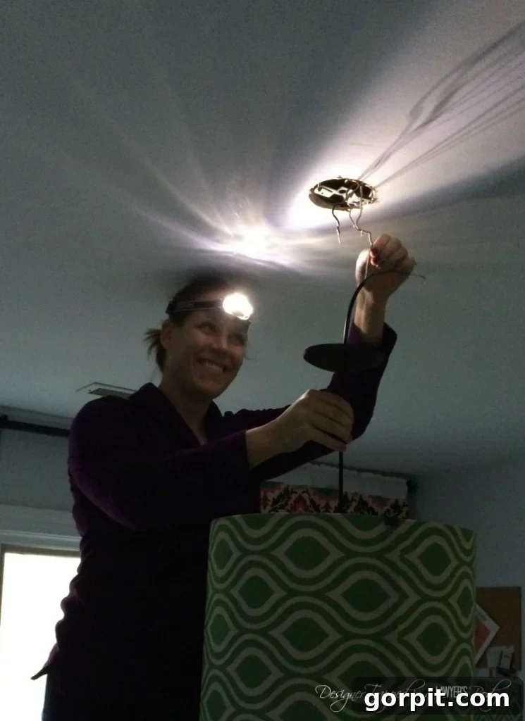 Craft Your Own Pendant Light 12 Enthusiastically installing the DIY pendant light, highlighting the importance of electrical safety precautions.