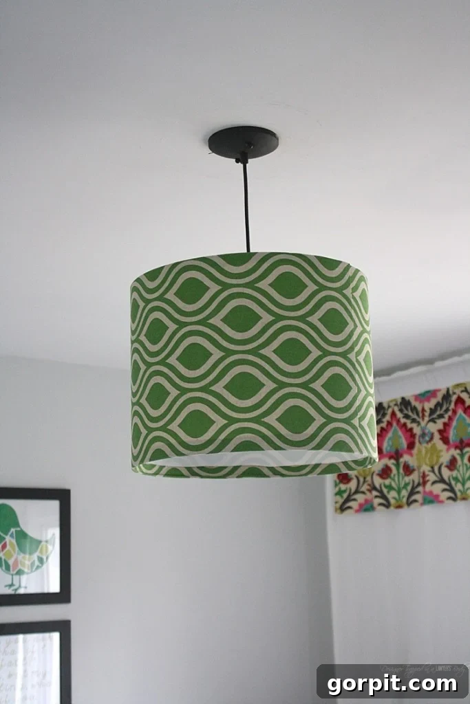 Craft Your Own Pendant Light 14 Side view of the DIY fabric pendant light, showcasing its drum shape and chosen pattern.