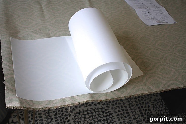Craft Your Own Pendant Light 6 Applying styrene backing to the fabric, ensuring a smooth, bubble-free surface for the drum shade.